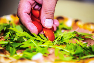 Close up hands of chef preparing pizza in the kitchen of a restaurant, cooking concept