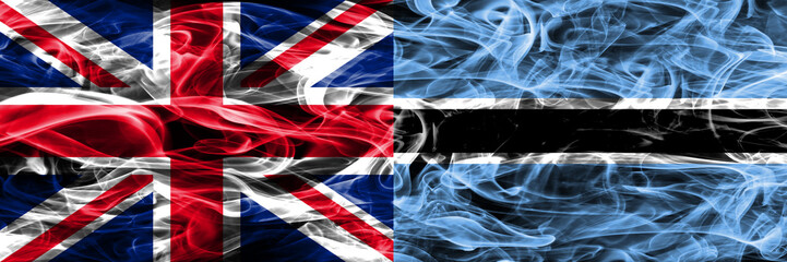 United Kingdom vs Botswana smoke flags placed side by side. Thick colored silky smoke flags of Great Britain and Botswana