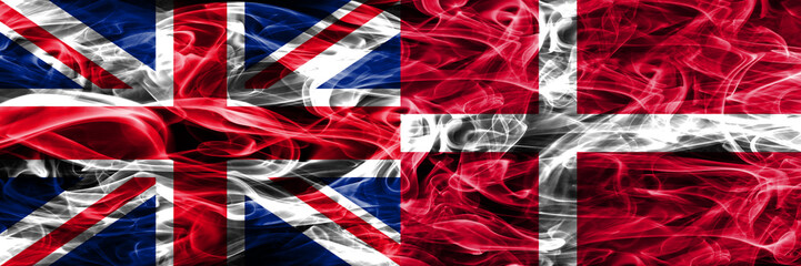 United Kingdom vs Denmark smoke flags placed side by side. Thick colored silky smoke flags of Great Britain and Denmark