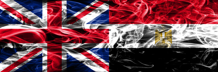 United Kingdom vs Egypt smoke flags placed side by side. Thick colored silky smoke flags of Great Britain and Egypt