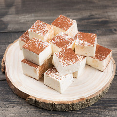 homemade candy bird's milk on wooden boards, tender soufflé, eco-friendly presentation, concept