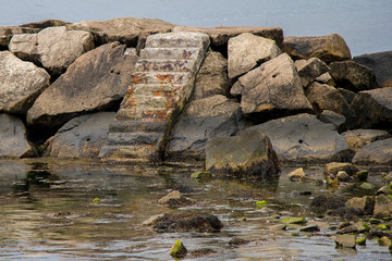 Cement, old stairs on rocks in Newport RI