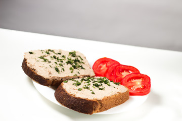Two sandwich made of pate with tomates