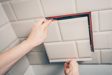Open sanitary hatch on the wall of the tile opens access to the plumbing and sewer systems at home
