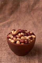walnut peanut in clay bowl. peanuts for food textures. peanut harvest. fried peanuts. texture of the nuts. photo for layout. Copyspace