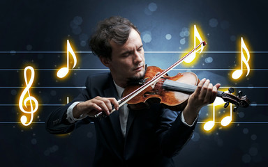 Young handsome fiddler playing with music sheet background