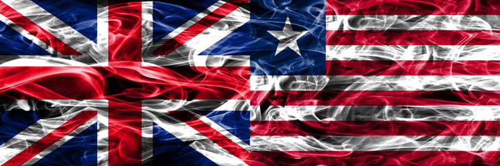 United Kingdom vs Liberia smoke flags placed side by side. Thick colored silky smoke flags of Great Britain and Liberia