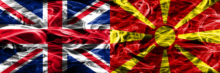United Kingdom vs Macedonia smoke flags placed side by side. Thick colored silky smoke flags of Great Britain and Macedonia