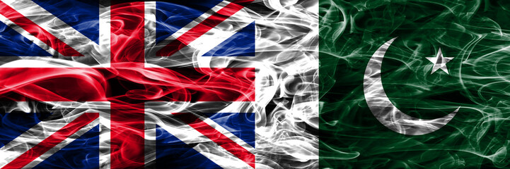 United Kingdom vs Pakistan smoke flags placed side by side. Thick colored silky smoke flags of Great Britain and Pakistan