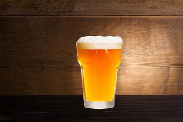 Glass of beer on wooden background with copyspace for text