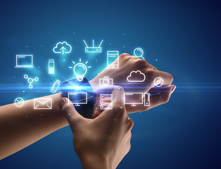 Close up female hand with smartwatch and multimedia symbols around and blue background
