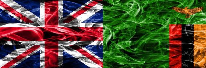 United Kingdom vs Zambia smoke flags placed side by side. Thick colored silky smoke flags of Great Britain and Zambia
