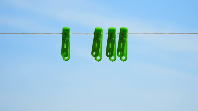 Clothespins on a rope against the sky