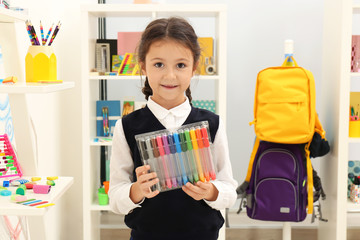 Cute child choosing school stationery in store