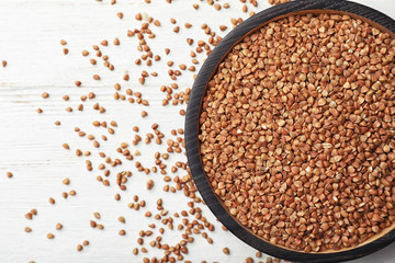 Bowl with buckwheat on table, top view. Grains and cereals