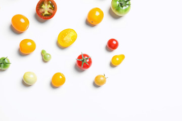 Flat lay composition with different tasty tomatoes on white background