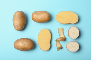 Fototapeta na wymiar Flat lay composition with fresh ripe organic potatoes on color background