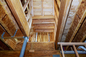 wooden beams at construction new residential house framing