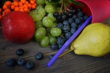 Ripe juicy fruits and berries on wooden background