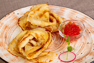 Russian pancakes with red caviar