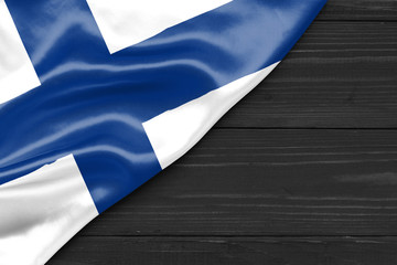 Flag of Finland and place for text on a dark wooden background
