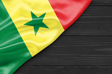 Flag of Senegal and place for text on a dark wooden background