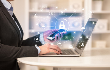 Business woman below chest working on laptop in a cozy homey environment with secured connection concept
