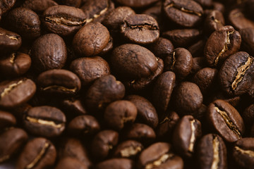 Coffee beans roasted on a wooden table with much of beans with a great aroma