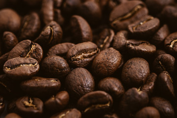 Coffee beans roasted on a wooden table with much of beans with a great aroma