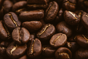 Coffee beans roasted on a wooden table with much of beans with a great aroma