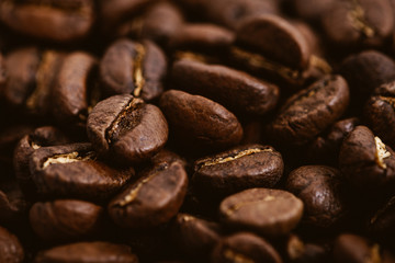 Coffee beans roasted on a wooden table with much of beans with a great aroma
