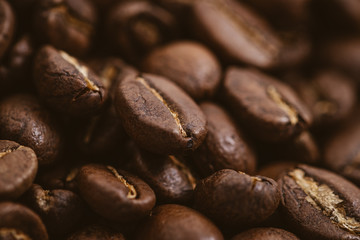 Coffee beans roasted on a wooden table with much of beans with a great aroma
