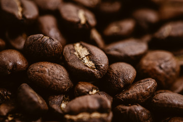 Coffee beans roasted on a wooden table with much of beans with a great aroma