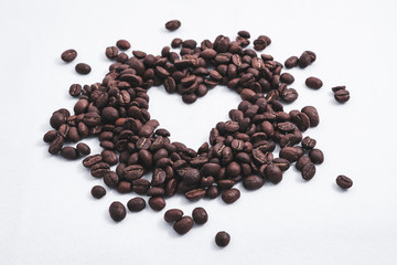 Heart with fresh roasted coffee beans on a white background with a great aroma