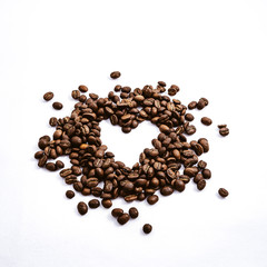 Heart with fresh roasted coffee beans on a white background with a great aroma