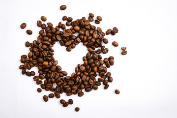 Heart with fresh roasted coffee beans on a white background with a great aroma