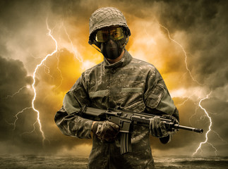 Armed soldier standing in rainy obscure weather
