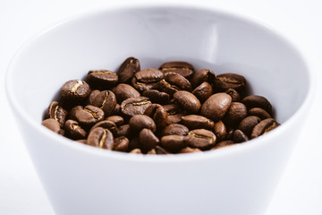 Cup of Coffee Beans roasted on a wooden table with fresh bean with great aroma