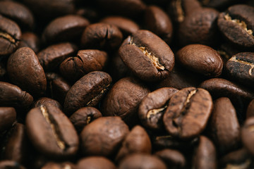 Coffee beans roasted on a wooden table with much of beans with a great aroma
