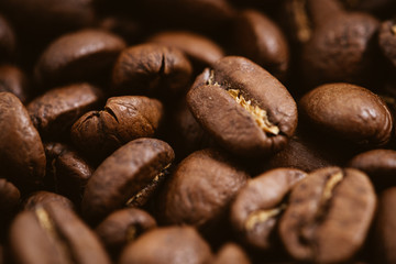 Coffee beans roasted on a wooden table with much of beans with a great aroma