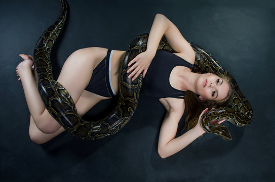 beautiful girl and big python in the studio