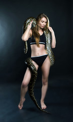 sensyal girl and tiger python in the studio
