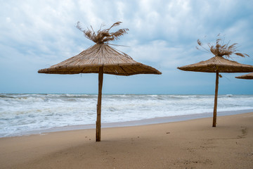 Straw umbrellas on the beach.
