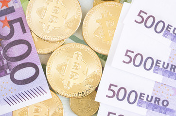 Photo of different type of currency: bitcoin and false euros.