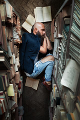 Tired young man student sleeping on floor while preparing exam