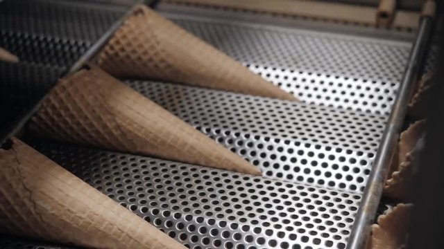The conveyor automatic lines for the production of ice cream cones. Wafer cups and cones. Large industrial production. A major supplier of ice cream to the retail network