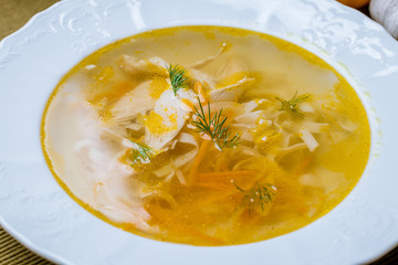 Chicken soup bouillon in a plate