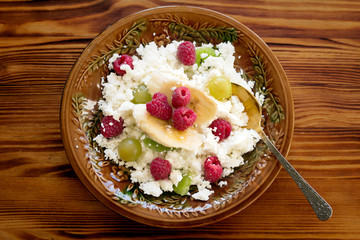 Healthy and delicious breakfast. Cottage cheese with fresh fruit (raspberry, kiwifruit, grapes).