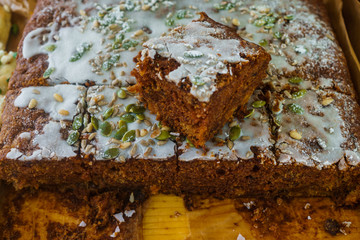 Delicious baked honey homemade pie filled with glaze and sprinkled with pine nuts and pumpkin seeds.