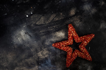 Red star on abstract black concrete background